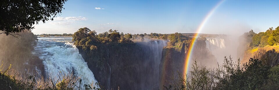 View of the Victoria Falls of the Zambezi River, border between Zambia (left side) and Zimbabwe (right side). The Victoria Falls is the largest sheet of falling water in the world based on its combined width of 1,708 metres (5,604&nbsp;ft) and height of 108 metres (354&nbsp;ft).